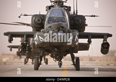 A group of AH-64D Apache helicopters on the runway at COB Speicher. Stock Photo