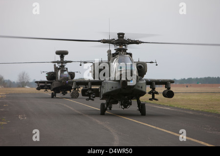 Two AH-64 Apache helicopters sit on the runway during flight operations, Conroe, Texas. Stock Photo