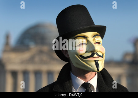 Berlin, Germany, the man with the Guy Fawkes mask of the internet collective Anoymous front of the Reichstag Stock Photo