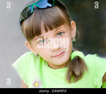The girl in a green blouse is photographed close-up Stock Photo