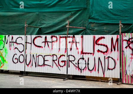 Anti-capitalist slogans and grafitti on hoardings, Nicosia, Cyprus Stock Photo