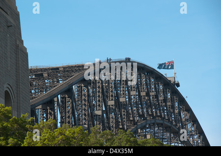 Sydney Harbor Bridge, Australia. Climbers enjoy a bird's eye view from the top of the iconic structure spanning the harbor. Stock Photo