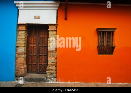 A Spanish colonial orange and blue wall in the neighborhood La Candelaria in Bogota, Colombia. Stock Photo