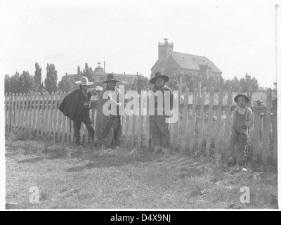 Three Native American Indian men crouching in the dead grasses hunting ...