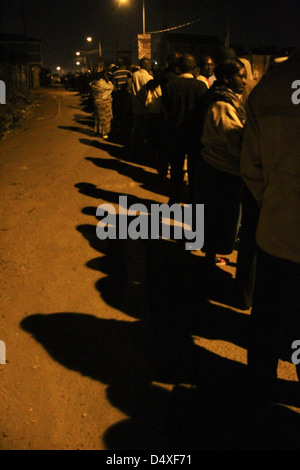 New Kihumbuini Primary School, Nairobi, Kenya - 4 March 2013: Shadows of voters seen on a road in Kangemi. © David Mbiyu/Alamy Live News Stock Photo