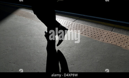 Commuter walking along the platform at Barbican underground station London England UK KATHY DEWITT Stock Photo