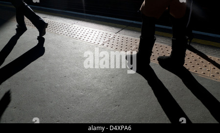 Commuters walking along the platform at Barbican underground station London England UK Stock Photo