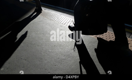 Commuters walking along the platform at Barbican underground station London England UK KATHY DEWITT Stock Photo