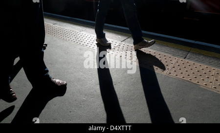 Commuters walking along the platform at Barbican underground station London England UK KATHY DEWITT Stock Photo