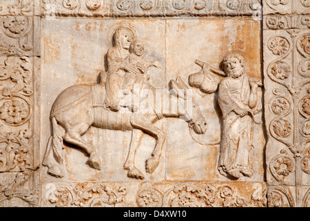 VERONA - JANUARY 27: Relief of Flight to Egypt from facade of romanesque Basilica San Zeno Stock Photo