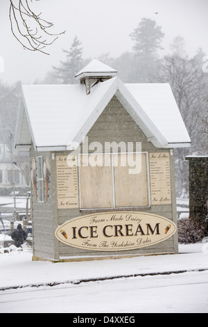 Snow on an ice cream kiosk in Ambleside, Lake District, UK. Stock Photo