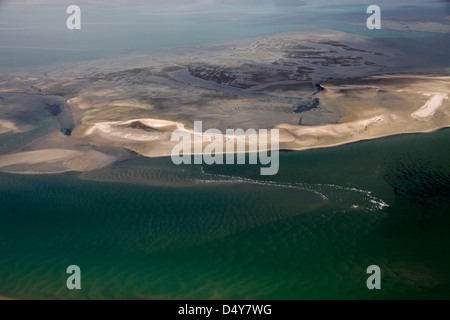 Namibia, Walvis Bay. Aerial view of flamingos in Walvis Bay lagoon, where the Namib Rand desert meets the sea. Stock Photo