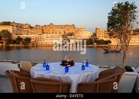 Asia, India, Udaipur. Table setting on rooftop restaurant Bhairo at Taj Lake Palace Hotel.