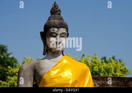 Thailand, Ayutthaya. Wat Phra Chao Phya-thai (aka Wat Yai Chai-mongkol). Buddha statue dressed in yellow robe. UNESCO