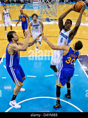 March 18, 2013 - New Orleans, Louisiana, United States of America - March 18, 2013: New Orleans Hornets small forward Al-Farouq Aminu (0) goes to the basket against Golden State Warriors point guard Stephen Curry (30) during the NBA basketball game between the New Orleans Hornets and the Golden State Warriors at the New Orleans Arena in New Orleans, LA. Stock Photo