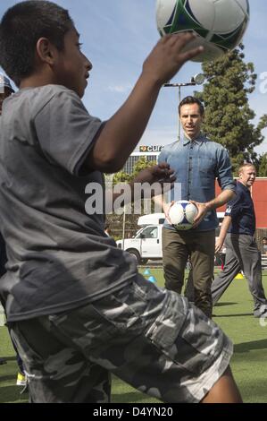 March 20, 2013 - Los Angeles, California, U.S. - Los Angeles Lakers point guard STEVE NASH watches as a young soccer player shows off his skills during a news conference to announce his foundation's charity soccer events, scheduled to take place in New York and Los Angeles this summer. (Credit Image: © Ringo Chiu/ZUMAPRESS.com) Stock Photo