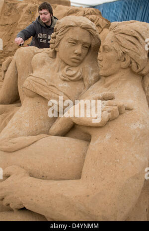 Binz, Germany. 20 March 2013. Sculptor Vadim Gryadov from Russia builds a sand sculpture from the novel 'Tarzan' at the sand sculpture festival in Binz, Germany, 20 March 2013. Around 50 artists from Russia, USA, Latvia and Poland are forming their sculptures from 12,000 of special sand. The show will take place in a tent from 23 March till the beginning of November 2013. Photo: STEFAN SAUER/DPA/Alamy Live News Stock Photo