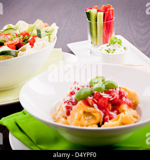 collection of different plates with healthy food pasta salad vegetables on wooden table