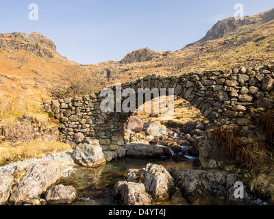 Lingcove bridge, an ancient packhorse bridge in the upper Esk, Lake District, UK. Stock Photo