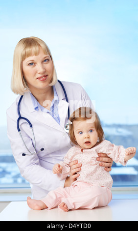 Portrait of a lovely pediatrician taking care of baby in hospital Stock Photo