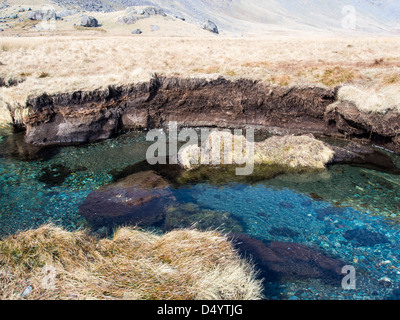 Huge blocks of peat ripped up by flooding in the upper Esk valley, Lake District, UK. Stock Photo