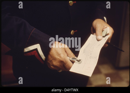 Conductor at Dodge City, Kansas, punches a ticket for a passenger on an eastbound Southwest Limited, June 1974 Stock Photo