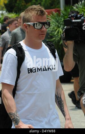 Sepang, Malaysia. March 21, 2013.   Lotus Renault Formula One driver Kimi Raikkonen of Finnish walking through paddock area in the Sepang International Circuit on Formula One 2013 Malaysian Grand Prix. Credit: Robertus Pudyanto/Aflo/Alamy Live News Stock Photo