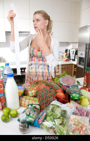 Woman looking at groceries price Stock Photo