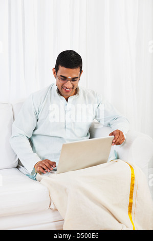 South Indian man using a laptop Stock Photo