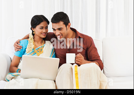 South Indian couple using a laptop Stock Photo