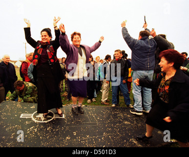 Serbian women dance atop the wing of an United States Air Force F-117A stealth fighter jet, which came down last night in Budjanovci, Serbia, on Sunday, March 28, 1999.. US special forces, based in Bosnia, rescued the pilot, who is now in Italy awaiting return to the United States. There is no word yet from NATO on whether the stealth fighter was shot down or crashed because of mechanical failure. This is the first time that a stealth airplane had ever come down during combat operations. Stock Photo