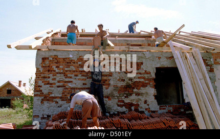 BRCKO, BOSNIA , 08 DECEMBER 1997 ---- Bosnian Moslem men rebuild their home in the contested Bosnian city of Brcko. Thousands of Moslems were ethnically cleansed from Brcko early on in the Bosnian conflict, but with NATO forces guaranteeing their safety many have returned. Stock Photo