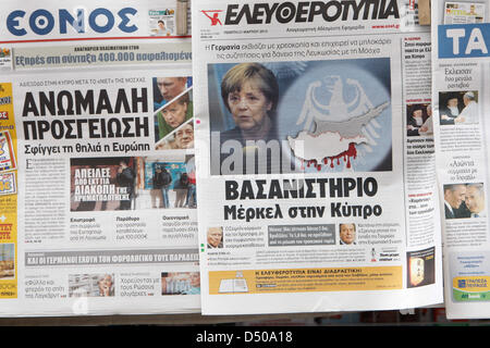 Athens, Greece. 21st March 2013. Man reads Greek newspaper in the center of Athens. Greek press slates Chancellor Angela Merkel for the situation in Cyprus. (Credit Image: Credit:  Aristidis Vafeiadakis/ZUMAPRESS.com/Alamy Live News) Stock Photo