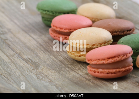 Selection of colorful macaroons on wooden background