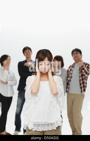 Woman getting excluded from a group Stock Photo