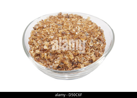 Brown rock candy in the glass bowl isolated on white background Stock Photo