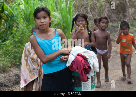 Amerindian girls boys of the Arawak tribe, on their way to the river to wash clothes and themselves. Fair View village. Iwokrama Stock Photo