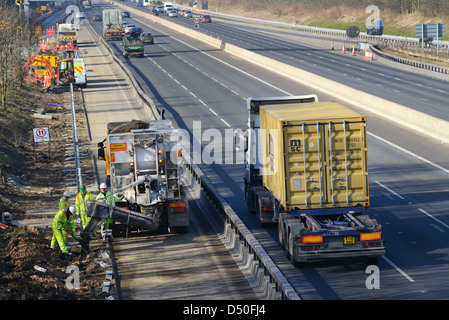 lorry delivering cement to construction workers working on M62 upgrade Leeds, Yorkshire, United Kingdom Stock Photo