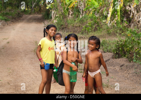 Amerindian girls boys of the Arawak tribe, on their way to the river to wash clothes and themselves. Fair View village. Iwokrama Stock Photo