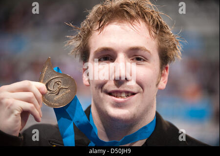 German swimmer Marco Koch shows his medal for  200 meters breaststroke during the European Aquatics Championships in Eindhoven, Netherlands, 28 November 2010. Photo: Bernd Thissen Stock Photo