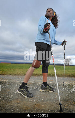 One-legged nordic walking athlete Asha Noppeney stands on a street in Eckersdorf, Germany, 13 November 2010. She lost a leg in an accident 50 years ago. Nowadays, she takes part in a Nordic Walking marathon and has published a book about her life. Photo: David Ebener Stock Photo