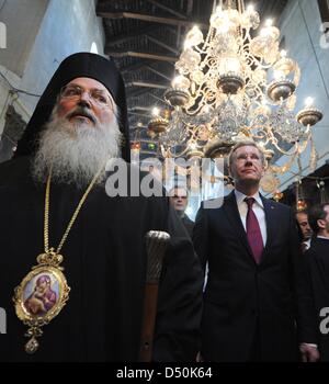 German President Christian Wulff (R) and his daughter Annalena (not pictured) walk through the Church of the Nativity together with Greek-Orthodox bishop Theoflakes (L) in Bethlehem, Palestinian Territories, 30 November 2010. The four-day state visit of German President Wulff will end today with his visit to the Palestinian Territories. Photo: RAINER JENSEN Stock Photo