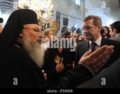 German President Christian Wulff (R), his daughter Annalena and Greek-Orthodox Bishop Theoflakes walk through the Church of the Nativity in Bethlehem, Palestinian Territories, 30 November 2010. The four-day state visit of German President Wulff will end today with his visit to the Palestinian Territories. Photo: RAINER JENSEN Stock Photo