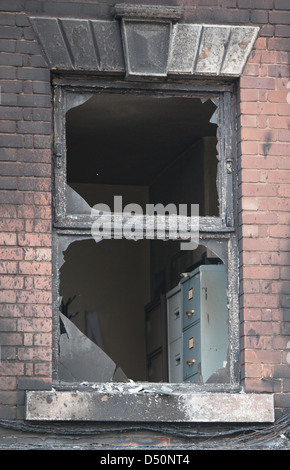 A fire blackened building after a severe fire. Upper floor windows ...