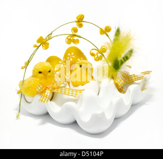 Easter decoration with eggs and small chickens on a white background. Stock Photo