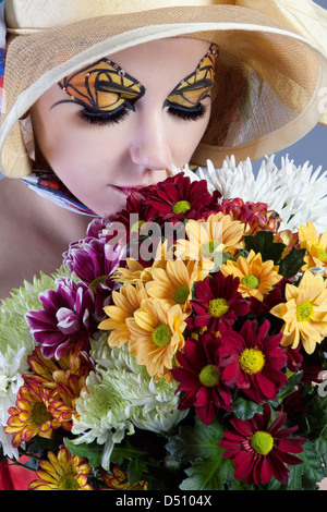 Woman with beautiful flowers and butterfly make-up Stock Photo