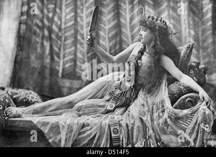 Lillie Langtry as Cleopatra, full-length portrait, lying on sofa and looking in mirror, circa 1891 Stock Photo