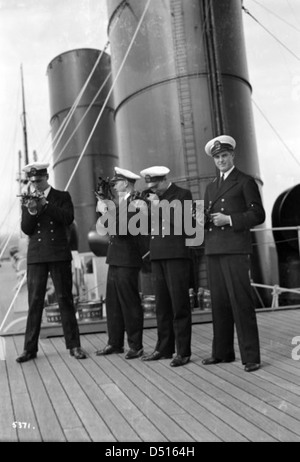 Four P & O cadets of the 'Viceroy of India' on the starboard side of the Bridge Deck with their sextants Stock Photo