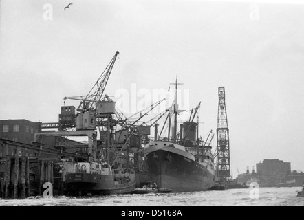 Hamburg, Germany, cargo ship at a pier with loading cranes in port Stock Photo