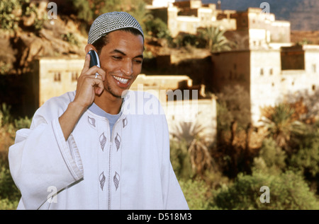 A Moroccan man in traditional dress speaking on a cell phone in the Ameln Valley Stock Photo